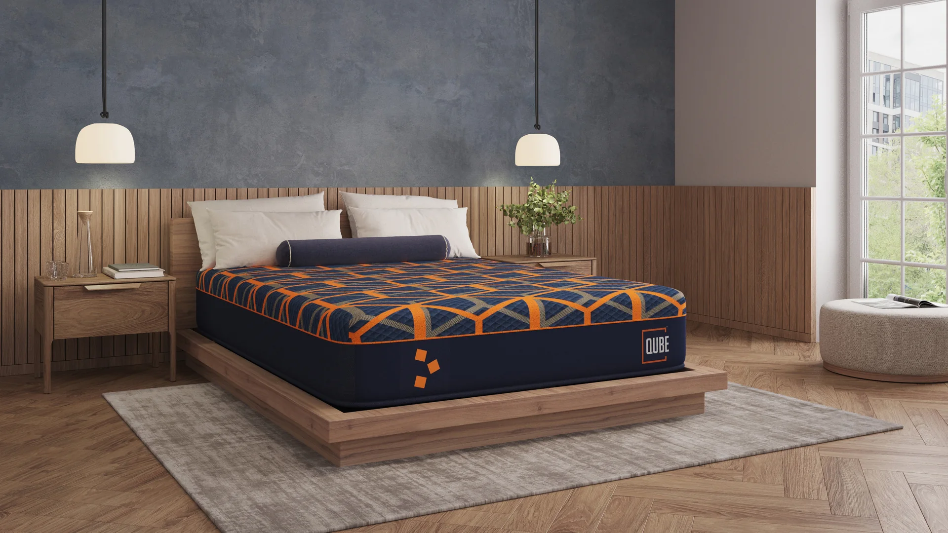 A Qube Indulge mattress made up on a low wooden platform bed in a bedroom with panelled walls and pendant lights